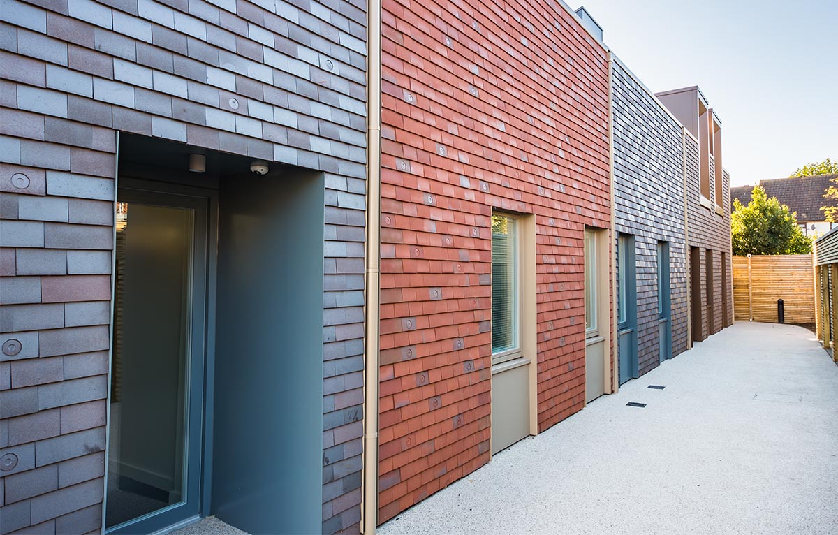 a range of Dreadnought plain clay tiles clad this new Harp Housing project in Southend by SKarchitects